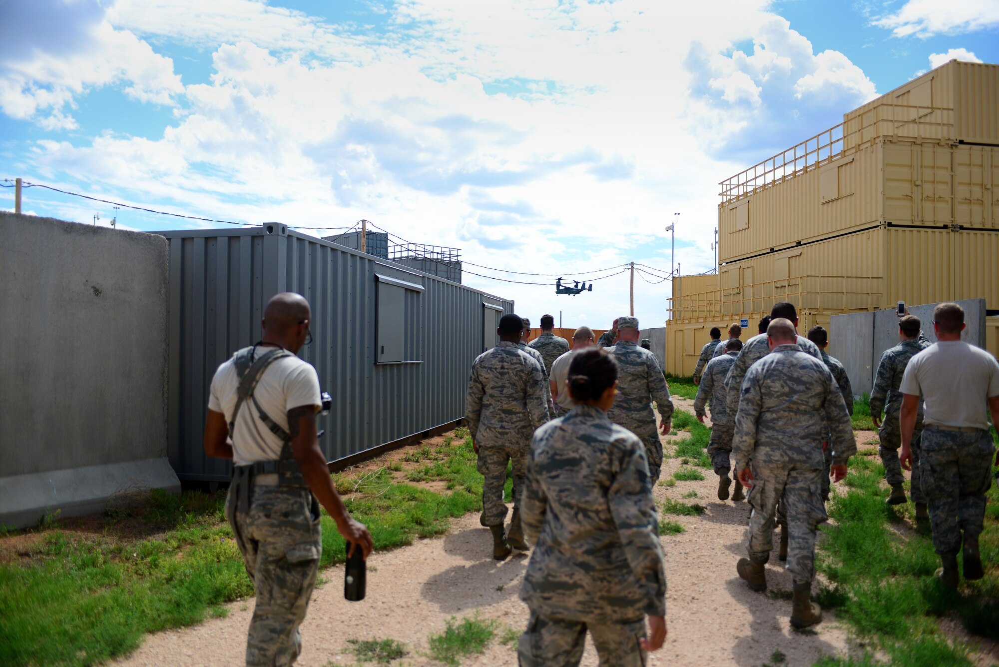 Airmen from 27th Special Operations Comptroller Squadron and 27th Special Operations Contracting Squadron walk toward the landing zone of a CV-22 Osprey during an exercise June 9, 2015 at Melrose Air Force Range, N.M. During the exercise, finance and contracting Air Commandos received financial training and practiced managing contracts and contract personnel in a contingency environment. (U.S. Air Force photo/Senior Airman Eboni Reece)