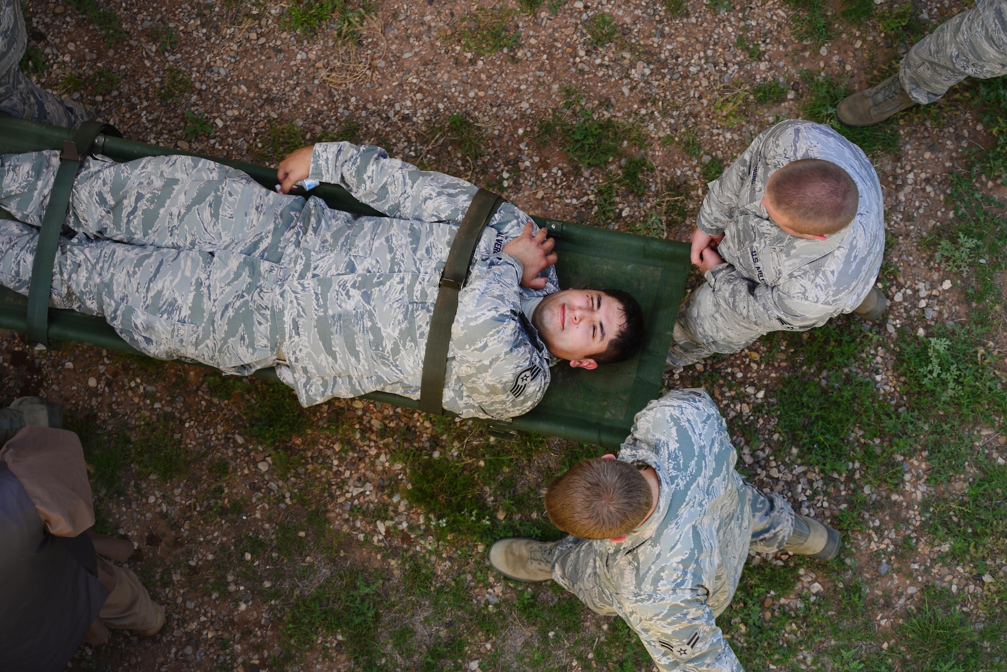 U.S. Air Force Airmen from the 27th Special Operations Contracting Squadron carry Staff Sgt. Octavio Valverde, 27th SOCONS contracting specialist, away from danger as part of an exercise June 9, 2015 at Melrose Air Force Range, N.M.  During the exercise, finance and contracting Air Commandos received financial training and practiced managing contracts and contract personnel in a contingency environment. (U.S. Air Force photo/Airman 1st Class Shelby Kay-Fantozzi)