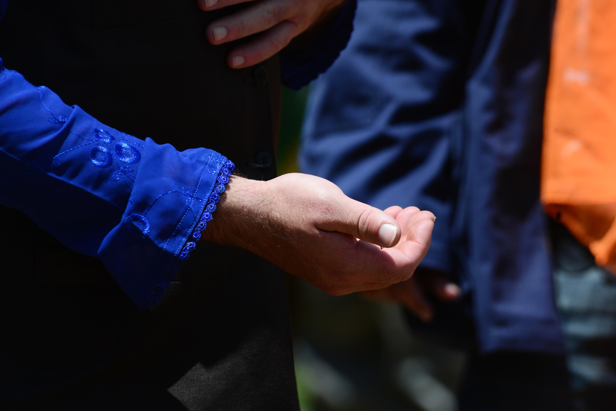 An opposing forces player extends a handshake to finance and contracting Air Commandos participating in an exercise June 9, 2015 at Melrose Air Force Range, N.M. During the exercise, finance and contracting Air Commandos received financial training and practiced managing contracts and contract personnel in a contingency environment. (U.S. Air Force photo/Airman 1st Class Shelby Kay-Fantozzi)