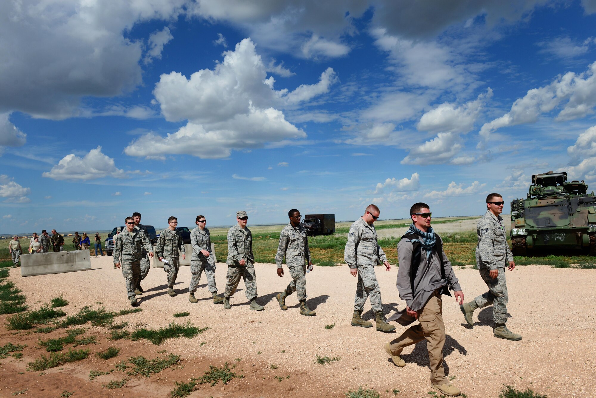 An opposing forces player leads finance and contracting Air Commandos to a potential contractor as part of an exercise June 9, 2015 at Melrose Air Force Range, N.M. During the exercise, finance and contracting Air Commandos received financial training and practiced managing contracts and contract personnel in a contingency environment. (U.S. Air Force photo/Airman 1st Class Shelby Kay-Fantozzi)