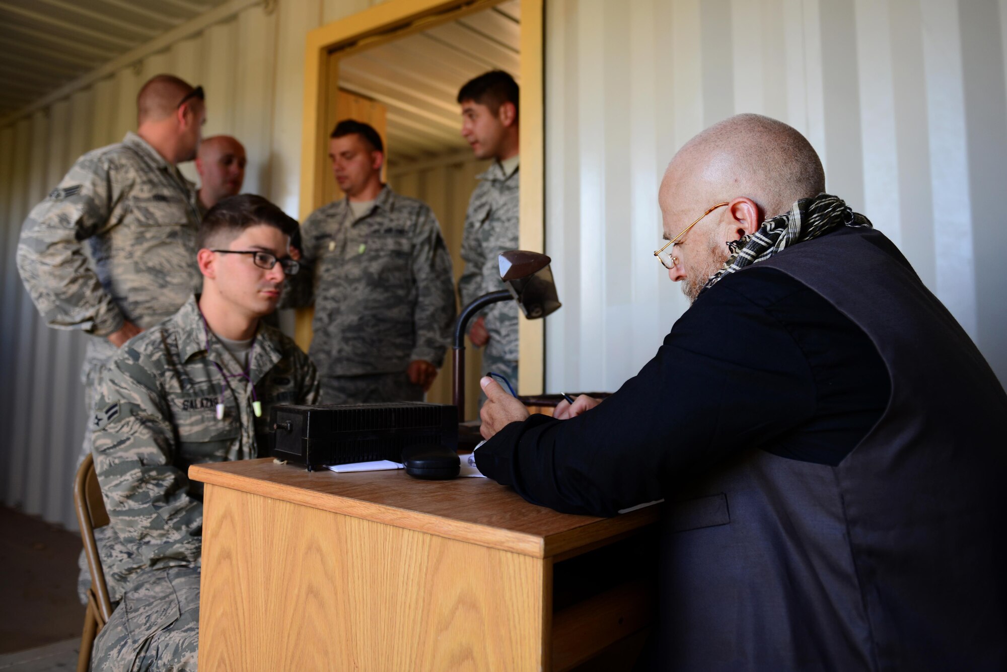 U.S. Air Force Airman 1st Class James Salazar, 27th Special Operations Contracting Squadron contracting specialist, negotiates a contract with opposing forces players acting as local entrepreneurs as part of an exercise June 9, 2015 at Melrose Air Force Range, N.M. During the exercise, finance and contracting Air Commandos received financial training and practiced managing contracts and contract personnel in a contingency environment. (U.S. Air Force photo/Airman 1st Class Shelby Kay-Fantozzi) 