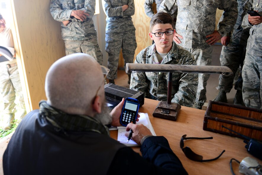 U.S. Air Force Airman 1st Class James Salazar, 27th Special Operations Contracting Squadron contracting specialist, negotiates a contract with opposing forces players acting as local entrepreneurs as part of an exercise June 9, 2015 at Melrose Air Force Range, N.M.  During the exercise, finance and contracting Air Commandos received financial training and practiced managing contracts and contract personnel in a contingency environment. (U.S. Air Force photo/Airman 1st Class Shelby Kay-Fantozzi)