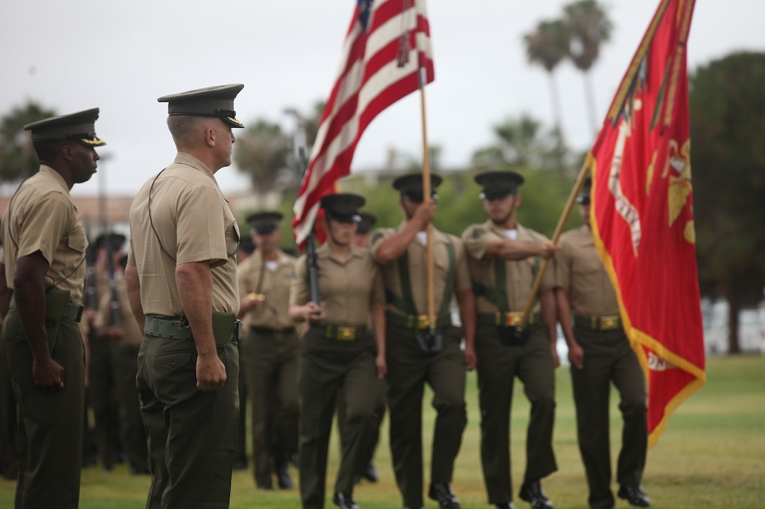 Lieutenant Col. Seth E. Anderson, the new commanding officer of 1st Intelligence Battalion, and Lt. Col. William T. Wilburn, the previous commanding officer of 1st Intel, observe the pass in review during a change of command ceremony aboard Marine Corps Base Camp Pendleton, Calif., June 11, 2015. The pass in review allows the incoming commanding officer to inspect the Marines in his charge as they march past.