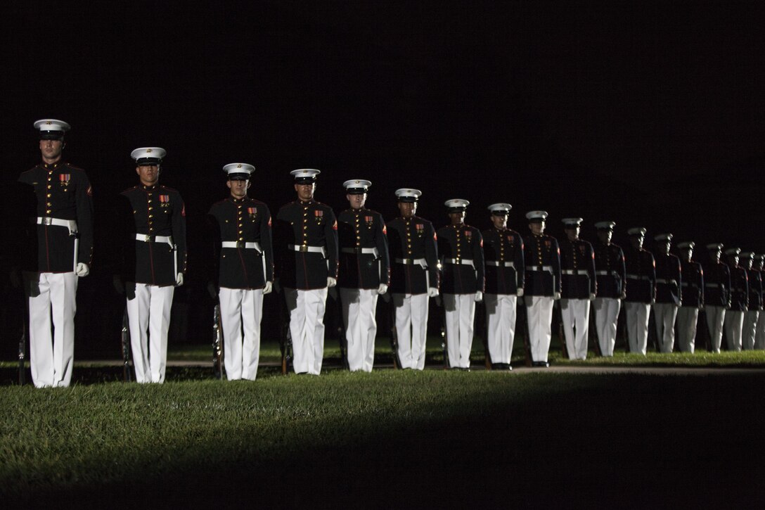 The Marine Corps Silent Drill Platoon preforms during the evening parade at Marine Barracks Washington, D.C., June 12, 2015. The Honorable Mac Thornberry was the guest of honor for the parade and Gen. John M. Paxton, assistant commandant of the Marine Corps, was the hosting official for that same parade. The Evening Parade summer tradition began in 1934 and features the Silent Drill Platoon, the U.S. Marine Band, the U.S. Marine Drum and Bugle Corps and two marching companies. More than 3,500 guests attend the parade every week. (U.S. Marine Corps Photo by Lance Cpl. Hailey D. Stuart/Released)