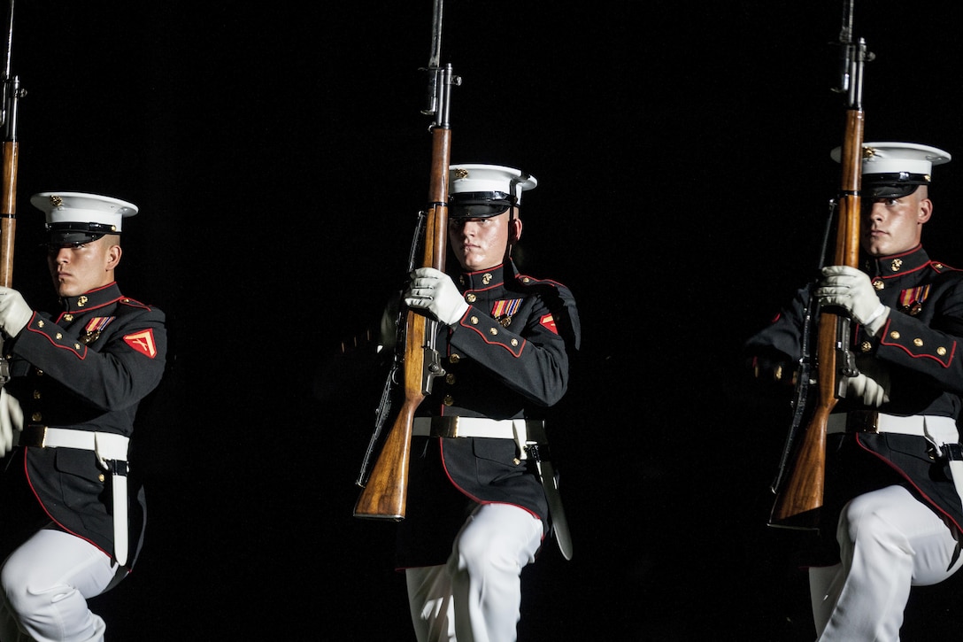 The U.S. Marine Corps Silent Drill Platoon performs during an evening parade at Marine Barracks Washington, D.C., June 12, 2015. The Honoroable Mac Thornberry was the guest of honor for the parade and Gen. John M. Paxton, assistant commandant of the Marine Corps, was the hosting official for that same parade. The Evening Parade summer tradition began in 1934 and features the Silent Drill Platoon, the U.S. Marine Band, the U.S. Marine Drum and Bugle Corps and two marching companies. More than 3,500 guests attend the parade every week.