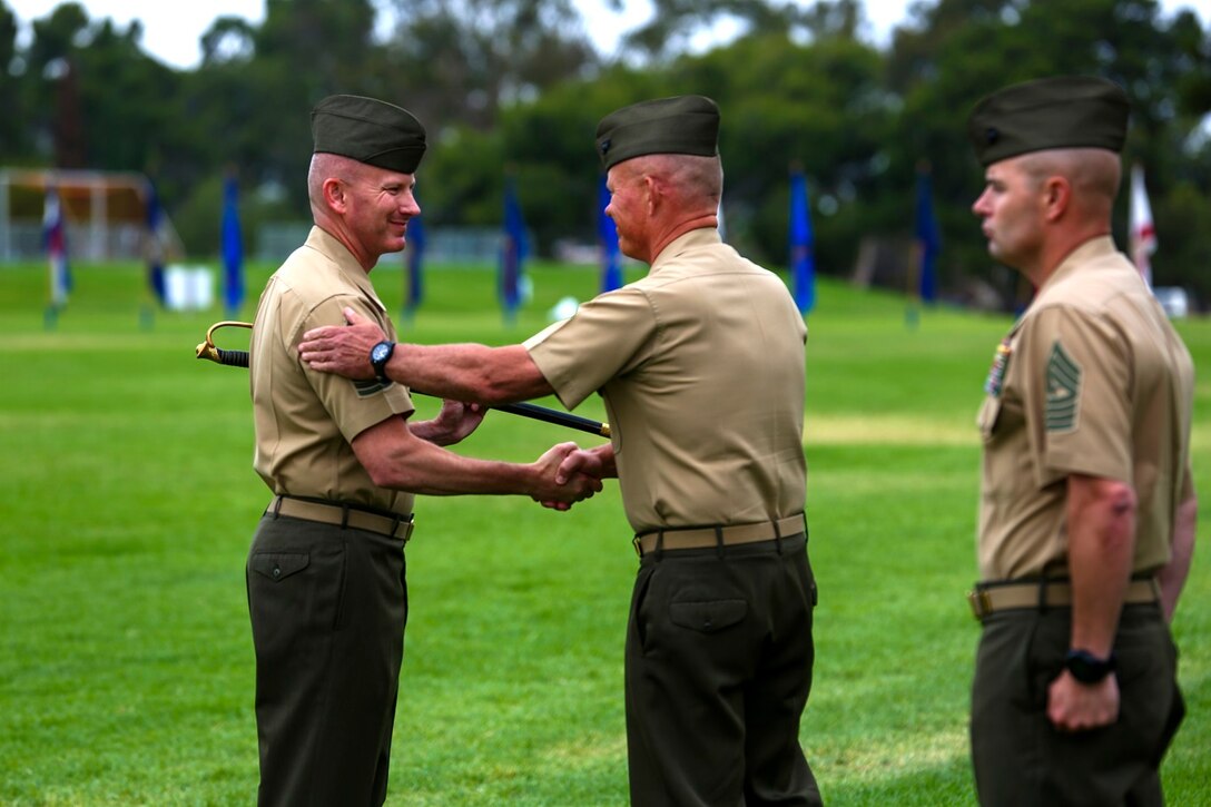 Sergeant Major William T. Sowers receives a Marine non-commissioned officer’s sword as he takes over the role of 1st Marine Division Sergeant Major during a relief and appointment ceremony aboard Marine Corps Base Camp Pendleton, Calif., June 12, 2015. Sowers most recently served as the sergeant major for the Marine Corps Training and Education Command in Quantico, Va.