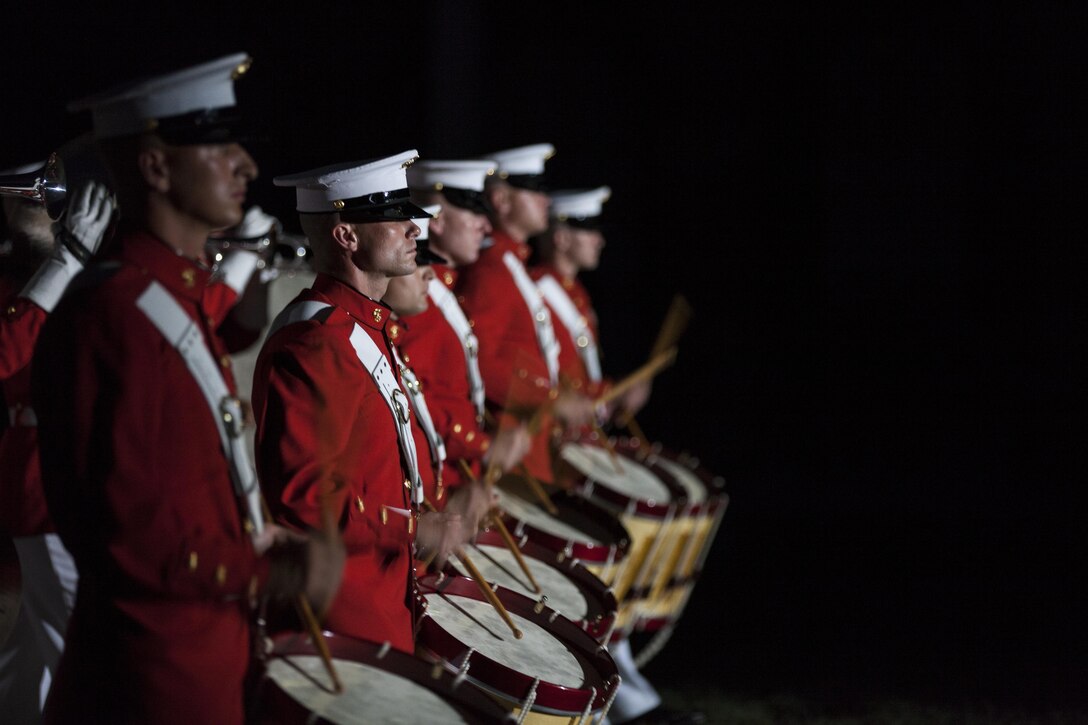 U.S. Marines with the Marine Corps Drum and Bugle Corps perform during an evening parade at Marine Barracks Washington, D.C., June 12, 2015. The Honorable Mac Thornberry was the guest of honor for the parade and Gen. John M. Paxton, assistant commandant of the Marine Corps, was the hosting official for that same parade. The Evening Parade summer tradition began in 1934 and features the Silent Drill Platoon, the U.S. Marine Band, the U.S. Marine Drum and Bugle Corps and two marching companies. More than 3,500 guests attend the parade every week. (U.S. Marine Corps Photo by Lance Cpl. Alex A. Quiles/ Released)
