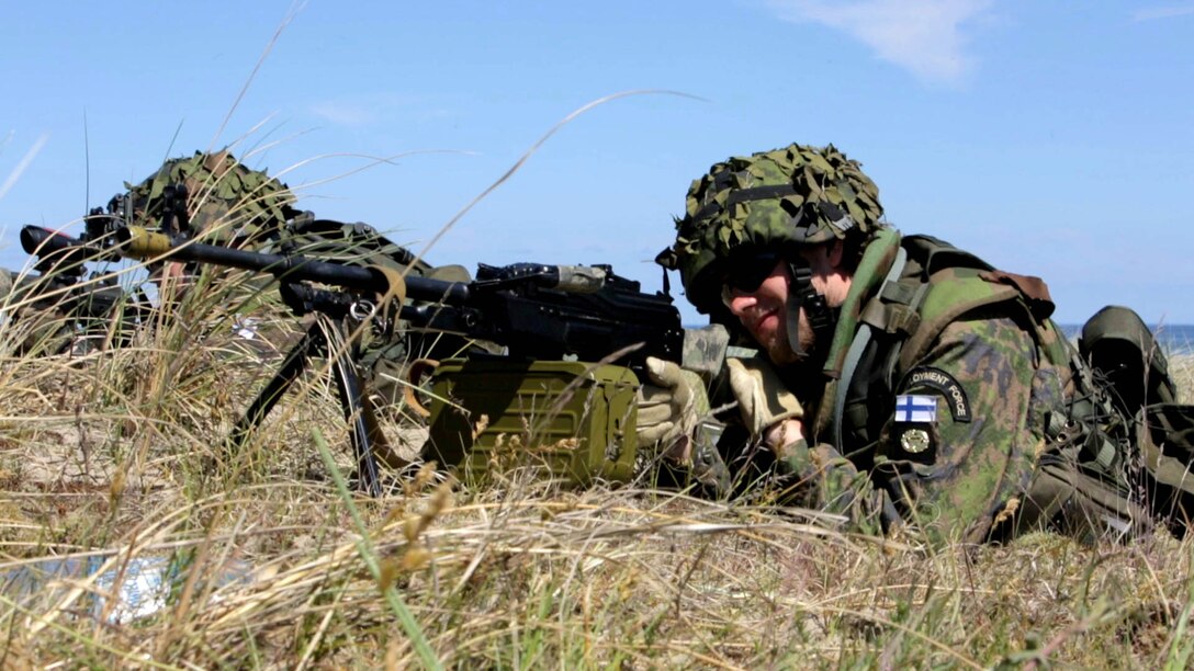 A Finnish Marine secures the perimeter for extraction to a Polish amphibious assault vehicle on a Swedish beachhead during BALTOPS 2015, June 11. BALTOPS is an annual, multinational exercise designed to enhance the operational familiarity of NATO Allies and partner nations and demonstrate the capabilities to defend the Baltic region.
