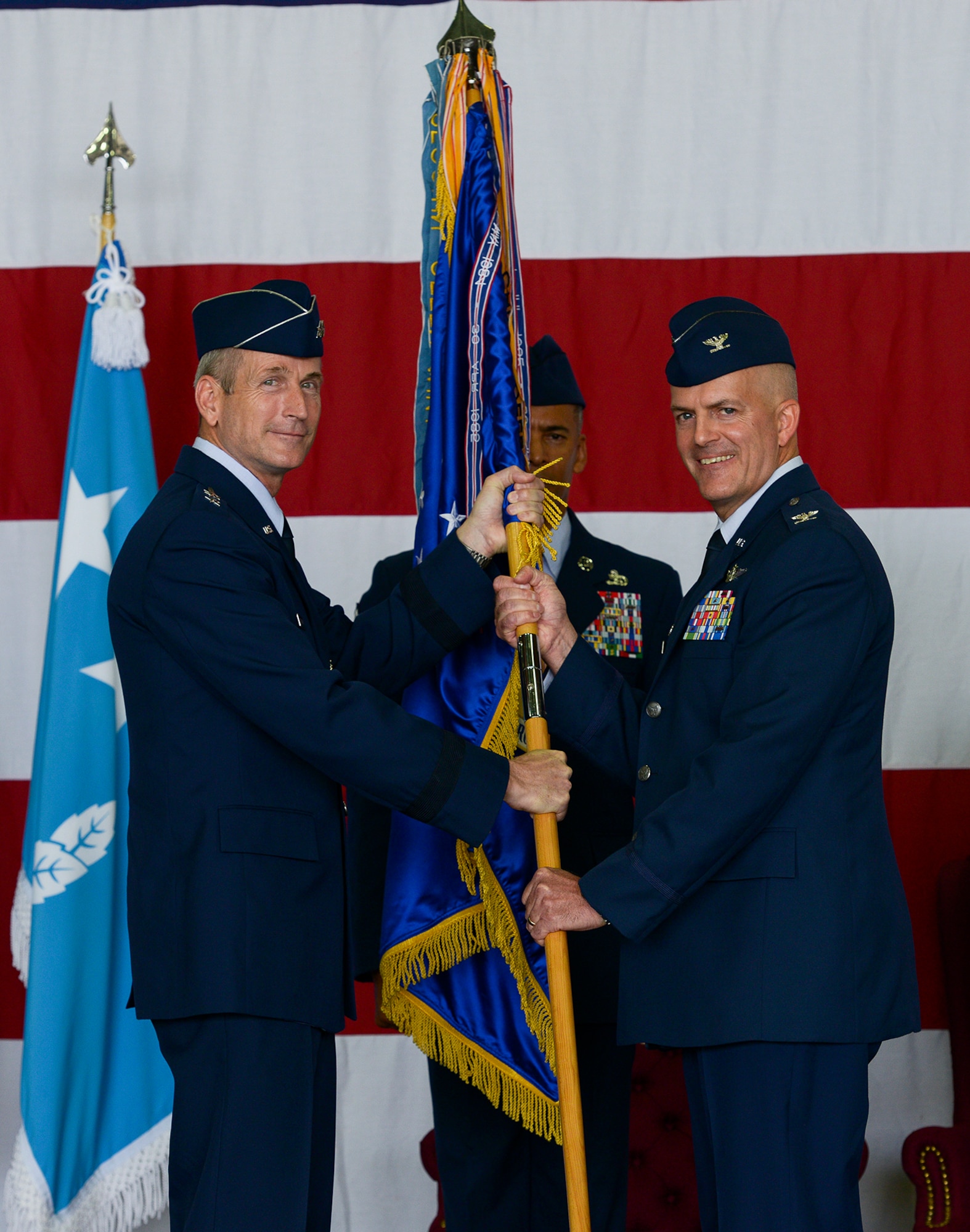Col. Andrew Hansen, incoming 51st Fighter Wing commander, accepts the guideon and command of the wing from Lt. Gen. Terrence O'Shaughnessy, 7th Air Force commander, during the 51st FW change of command ceremony June 16, 2015, at Osan Air Base, Republic of Korea. Hansen is the 63rd commander in the wing's history. (U.S. Air Force photo by Staff Sgt. Jake Barreiro/Released)
