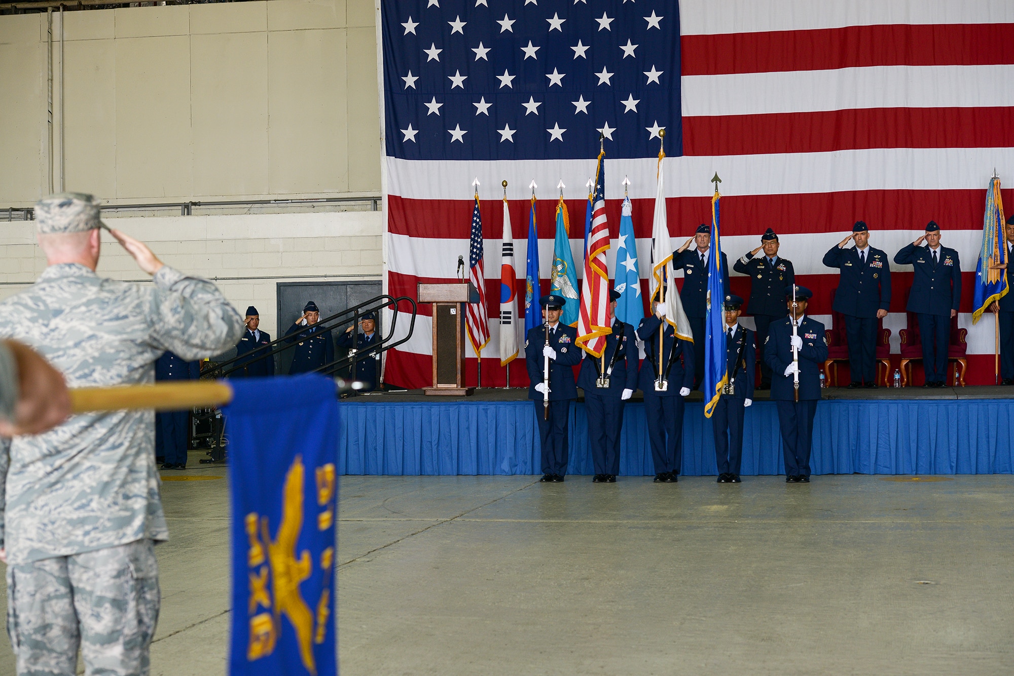 The honor guard presents the colors as the 51st Fighter Wing formation salutes during the 51st FW change of command ceremony June 16, 2015, at Osan Air Base, Republic of Korea. The ceremony transfered command of the 66-year-old fighter wing. (U.S. Air Force photo by Staff Sgt. Jake Barreiro/Released)