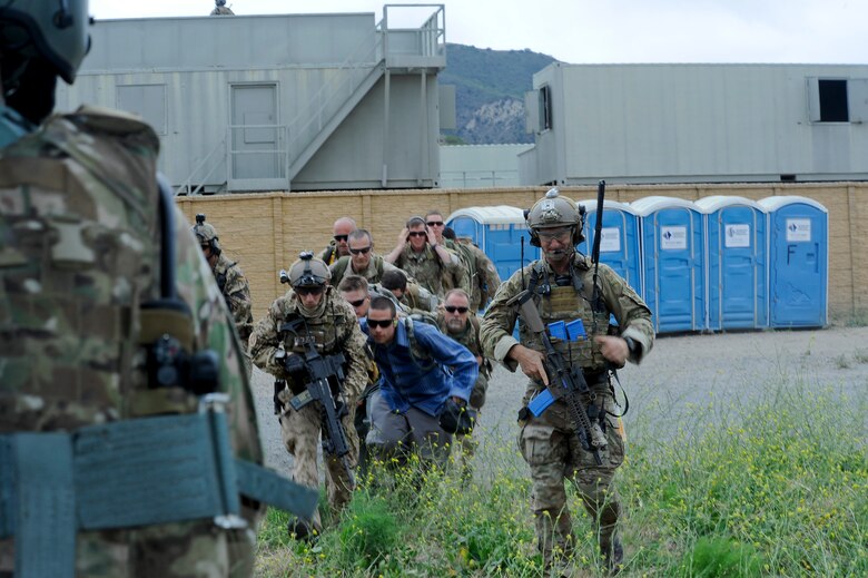 U.S. and German Air Force pararescuemen prepare to load simulated casualties onto an HH-60G Pave Hawk from the 66th Rescue Squadron during an Angel Thunder 2015 mass casualty exercise outside of Marine Corps Base Camp Pendleton, Calif., June 11, 2015. The objective of the exercise was to clear the area of opposing forces and stablilze and safely extricate simulated casualties. The 66th RQS is stationed at Nellis Air Force Base, Nev. (U.S. Air Force photo by Senior Airman Betty R. Chevalier/Released)