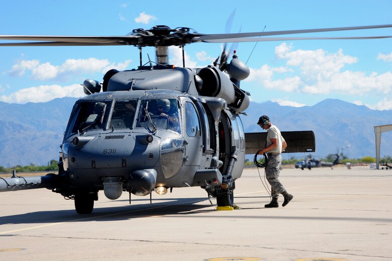 U.S. Air Force Airman 1st Class Andres Martinez, 823d Maintenance Squadron HH-60G Pave Hawk crew chief, prepares to launch a HH-60G Pave Hawk from the 66th Rescue Squadron for a mass casualty exercise during Angel Thunder 2015, at Davis-Monthan Air Force Base, Ariz., June 11, 2015. Angel Thunder is the world’s largest personnel recovery exercise, hosting 11 partner nations and nine inter-agencies at Davis-Monthan AFB. Martinez and the 66th RQS are stationed at Nellis AFB, Nev.  (U.S. Air Force photo by Senior Airman Betty R. Chevalier/Released)