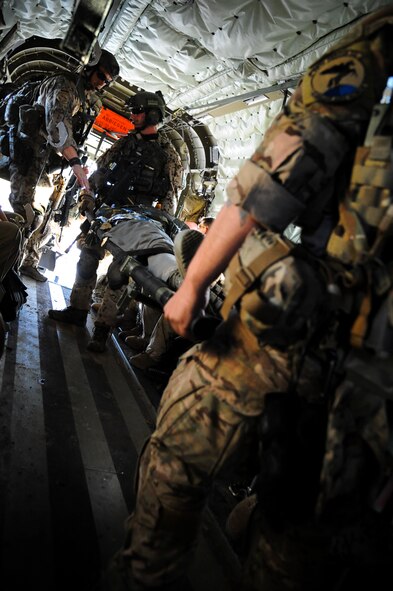 German and U.S. Air Force pararescuemen move a simulated patient from a CH-53GS helicopter to a C-130 Hercules for transportation during an Angel Thunder 2015 mass casualty exercise at Bisbee-Douglas International Airport, Ariz., June 9, 2015. Angel Thunder is the largest personnel recovery exercise in the world combining joint, coalition and interagency personnel that will train through the full spectrum of personnel recovery capabilities with numerous types of aircraft. (U.S. Air Force photo by Senior Airman Betty R. Chevalier/Released)