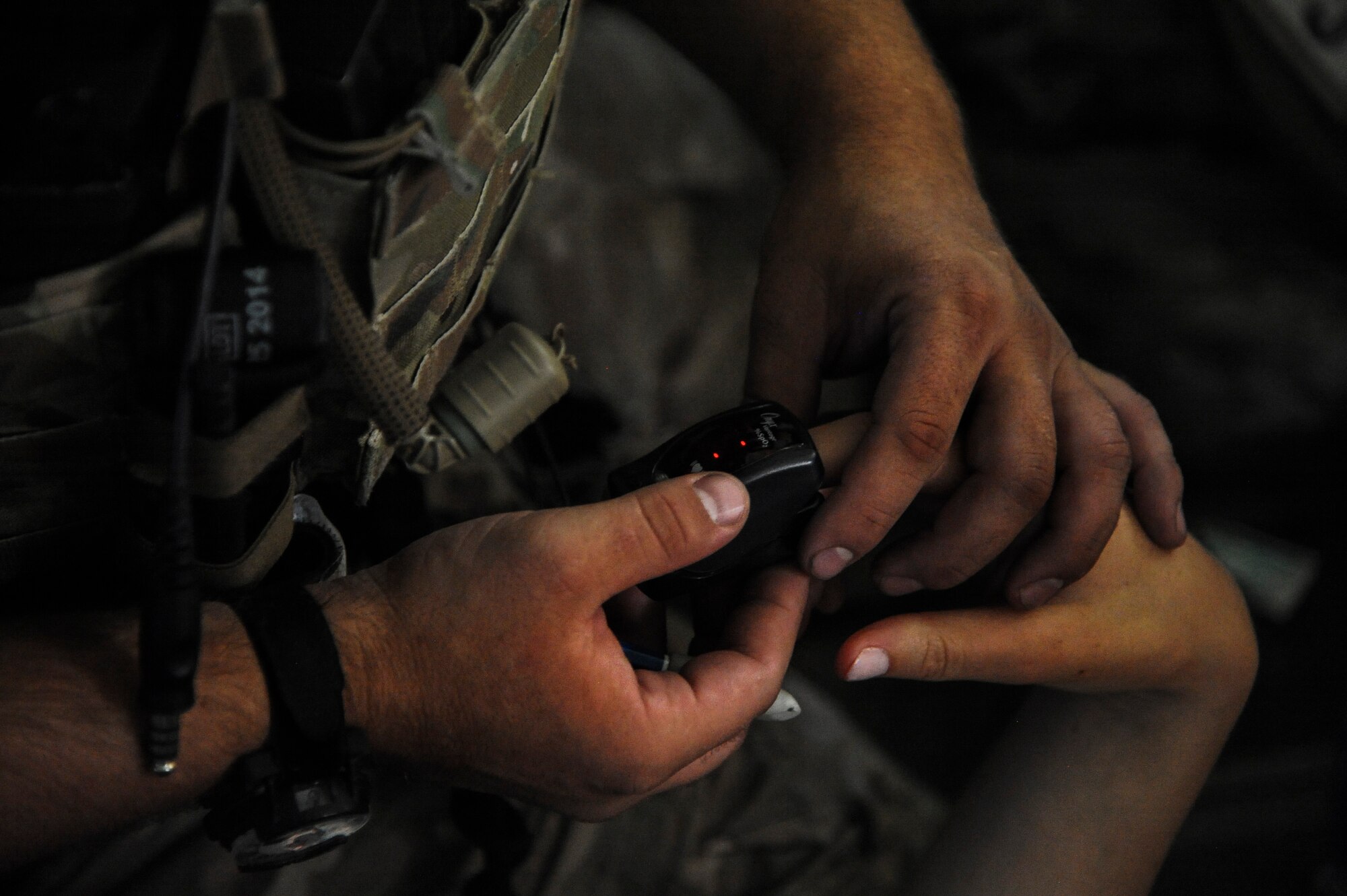 A U.S. Air Force 48th Rescue Squadron pararescueman checks the vitals of a simulated patient during an Angel Thunder 2015 mass casualty exercise in route to Bisbee-Douglas International Airport, Ariz., June 9, 2015. Rescue personnel came under simulated enemy fire during the exercise, where A-10 Thunderbolt IIs neutralized and secured the area of responsibility. (U.S. Air Force photo by Senior Airman Betty R. Chevalier/Released)
