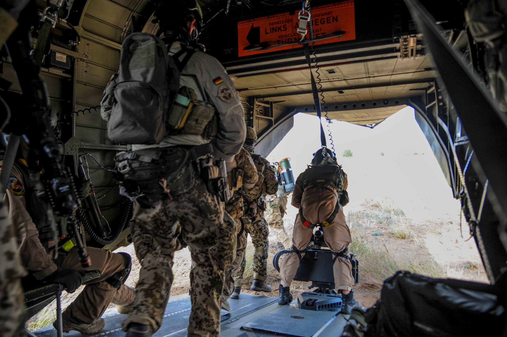 German and U.S. Air Force pararescuemen depart a CH-53GS helicopter to join partner nation rescue personnel for an Angel Thunder 2015 mass casualty exercise at the Playas Research and Training Center, N.M, June 9, 2015. Angel Thunder is the world’s largest personnel recovery exercise, hosting 11 partner nations and nine interagencies at Davis-Monthan Air Force Base in Tucson, Ariz. (U.S. Air Force photo by Senior Airman Betty R. Chevalier/Released)