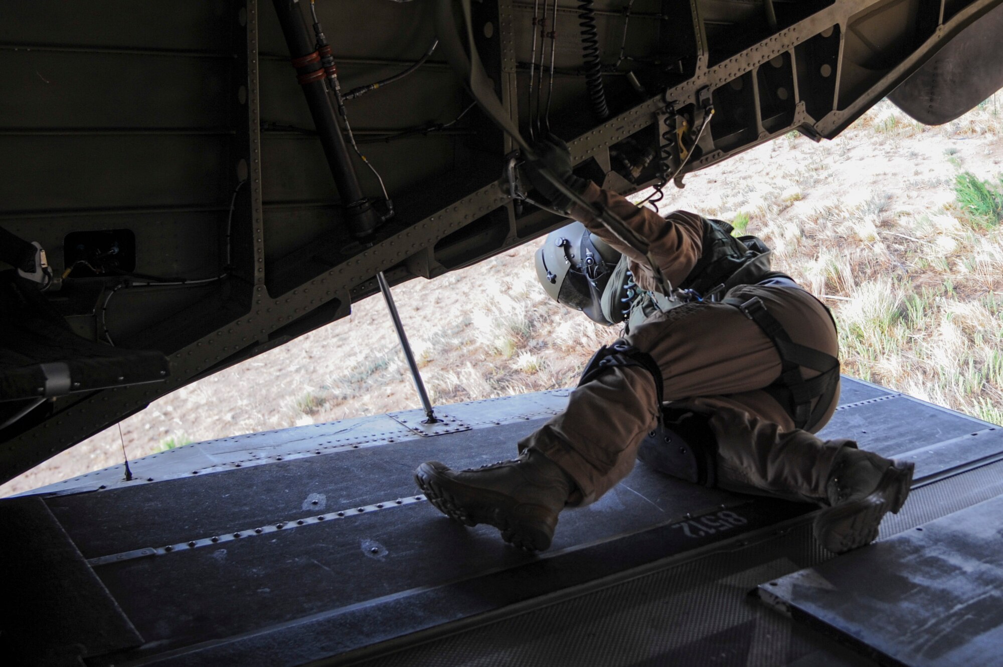 A German Air Force Helicopter Wing 64 flight engineer monitors a landing zone from the ramp of a CH-53GS helicopter as it lands in a field at the Playas Research and Training Center, N.M to drop off German and U.S. Air Force pararescuemen for an Angel Thunder 2015 mass casualty exercise, June 9, 2015. Rescue personnel were called in to clear a simulated town and locate survivors after a security team patrolling a safe house hit an improvised explosive device. (U.S. Air Force photo by Senior Airman Betty R. Chevalier/Released)
