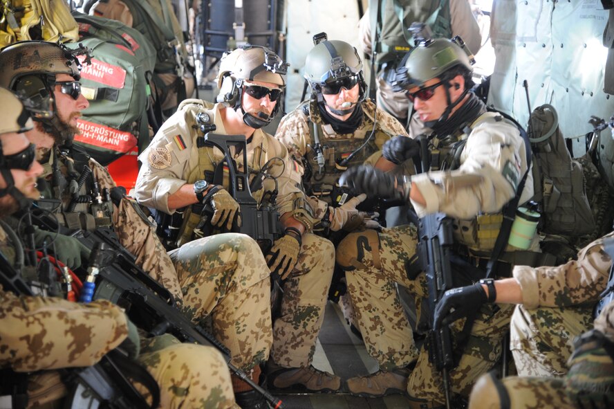 German Air Force Helicopter Wing 64 pararescuemen discuss the mission on the way to the Playas Research and Training Center, N.M., where partner nations teamed up to participate in an Angel Thunder 2015 mass casualty exercise, June 9, 2015. The objective of Angel Thunder is to train personnel recovery forces to prepare, plan, execute and adapt for a rescue mission. (U.S. Air Force photo by Senior Airman Betty R. Chevalier/Released)