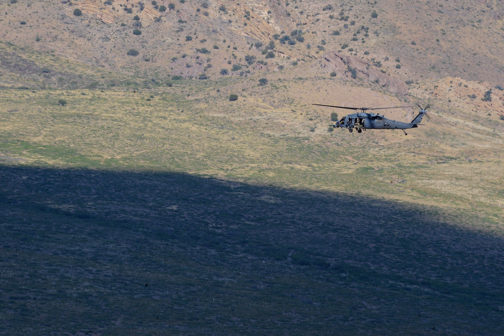 A German Air Force Helicopter Wing 64 pararescueman holds his weapon during Angel Thunder 2015, June 9, 2015. The German Air force transported the pararescueman to the Playas Research and Training Center, N.M., to assist partner nations locate and extract the simulated victims of an explosion. (U.S. Air Force photo by Senior Airman Betty R. Chevalier/Released)