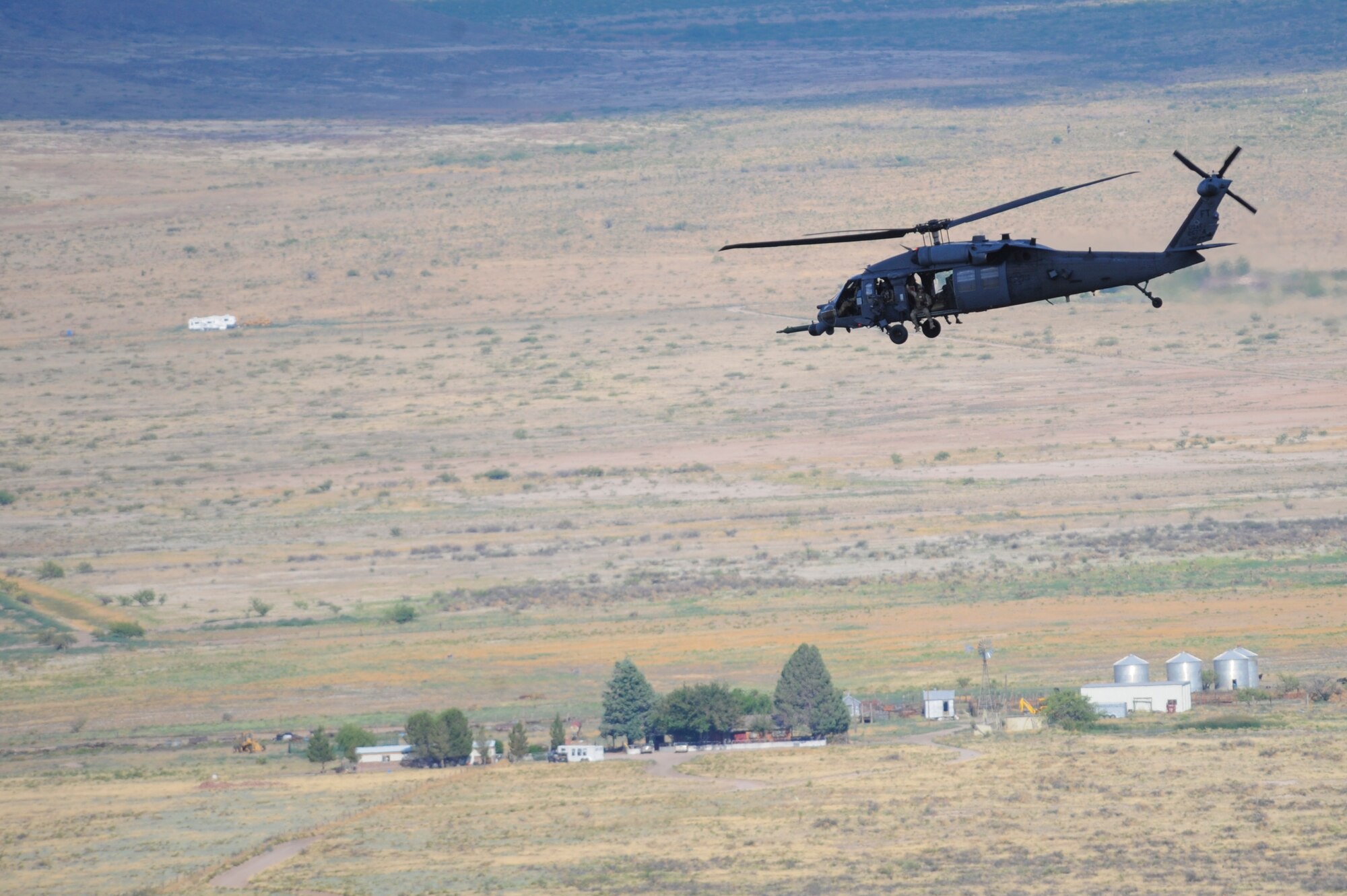 A German Air Force Helicopter Wing 64 pararescueman holds his weapon during Angel Thunder 2015, June 9, 2015. The German Air force transported the pararescueman to the Playas Research and Training Center, N.M., to assist partner nations locate and extract the simulated victims of an explosion. (U.S. Air Force photo by Senior Airman Betty R. Chevalier/Released)