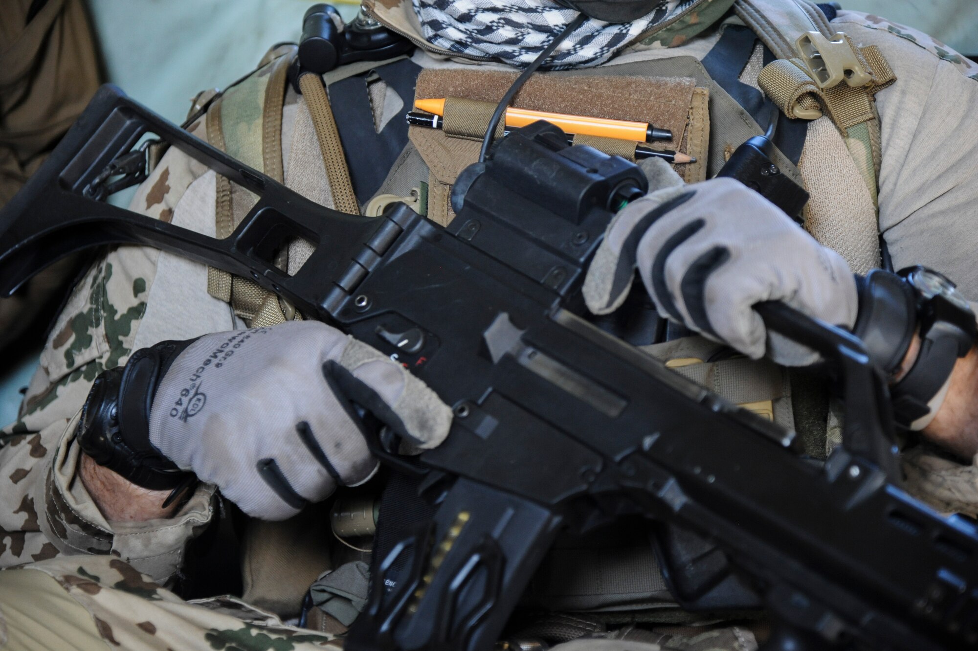 A German Air Force Helicopter Wing 64 pararescueman holds his weapon during Angel Thunder 2015, June 9, 2015. The German Air force transported the pararescueman to the Playas Research and Training Center, N.M., to assist partner nations locate and extract the simulated victims of an explosion. (U.S. Air Force photo by Senior Airman Betty R. Chevalier/Released)
