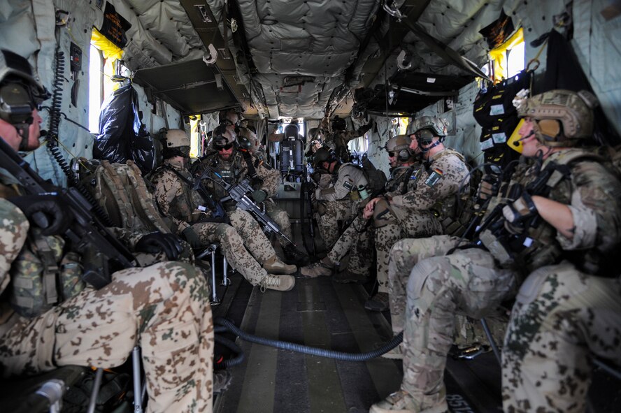 German and U.S. Air Force pararescuemen sit in the back of a CH-53GS helicopter on the way to the Playas Research and Training Center, N.M., where partner nations teamed up to participate in an Angel Thunder 2015 mass casualty exercise, June 9, 2015. The objective of Angel Thunder is to train personnel recovery forces to prepare, plan, execute and adapt for a rescue mission. (U.S. Air Force photo by Senior Airman Betty R. Chevalier/Released)