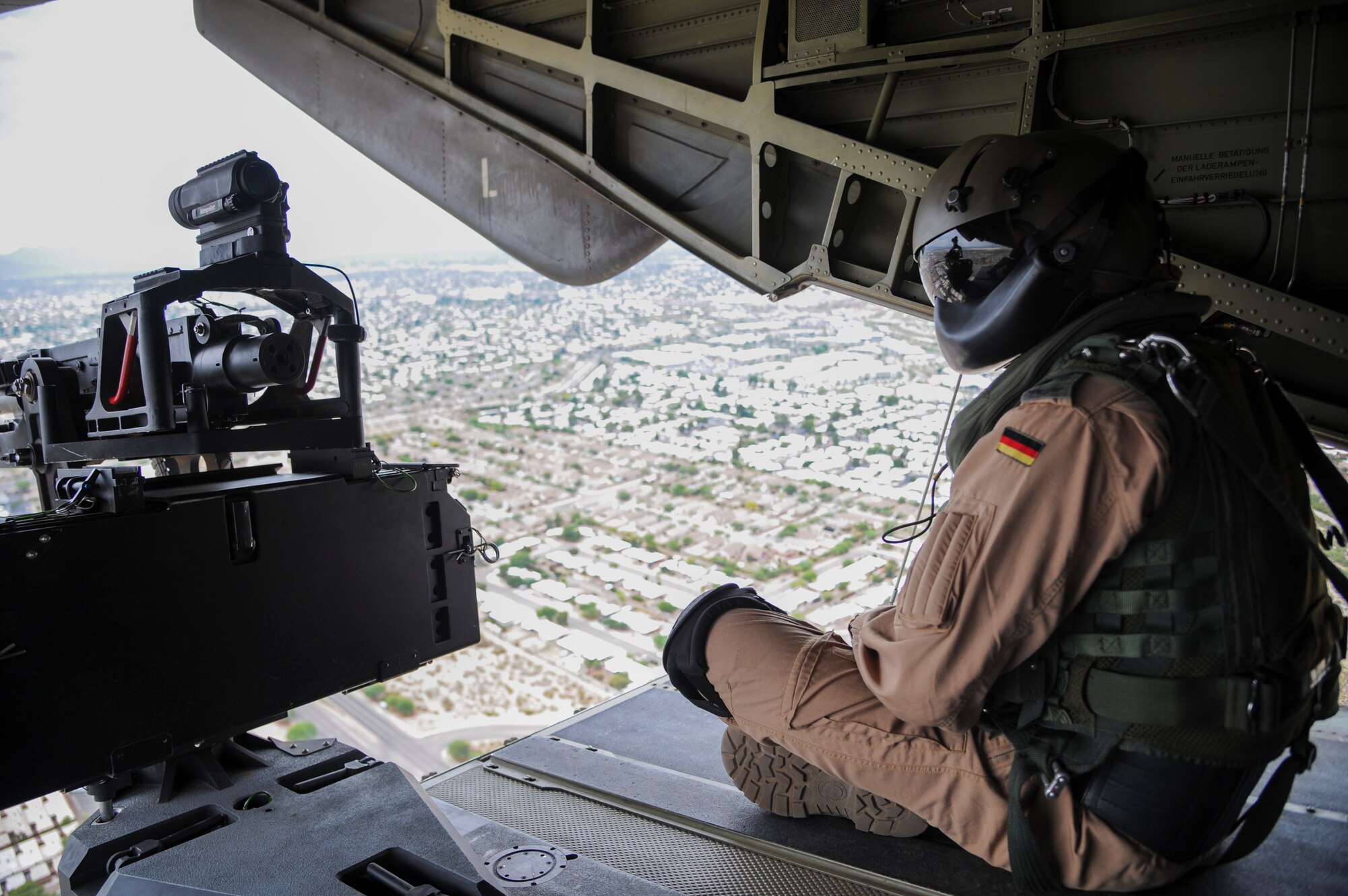 A German Air Force Helicopter Wing 64 aerial gunner views Tucson, Ariz., from the ramp of a German Air Force CH-53GS helicopter during Angel Thunder 2015, June 9, 2015. Angel Thunder is hosted by the 355th Fighter Wing at Davis-Monthan Air Force Base, Ariz., but many flying operations extend throughout Arizona, New Mexico and California. (U.S. Air Force photo by Senior Airman Betty R. Chevalier/Released)
