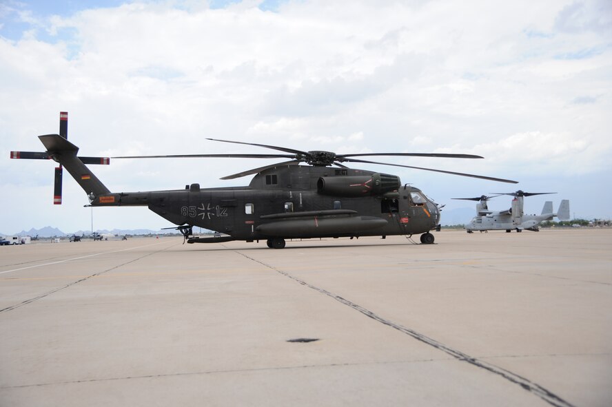 A German Air Force CH-53GS and a U.S. Marine MV-22 Osprey sit on the flightline during Angel Thunder 2015 at Davis-Monthan Air Force Base, Ariz., June 9, 2015. Angel Thunder is the largest personnel recovery exercise in the world combining joint, coalition and interagency personnel that will train through the full spectrum of personnel recovery capabilities with numerous types of aircraft.  (U.S. Air Force photo by Senior Airman Betty R. Chevalier/Released)
