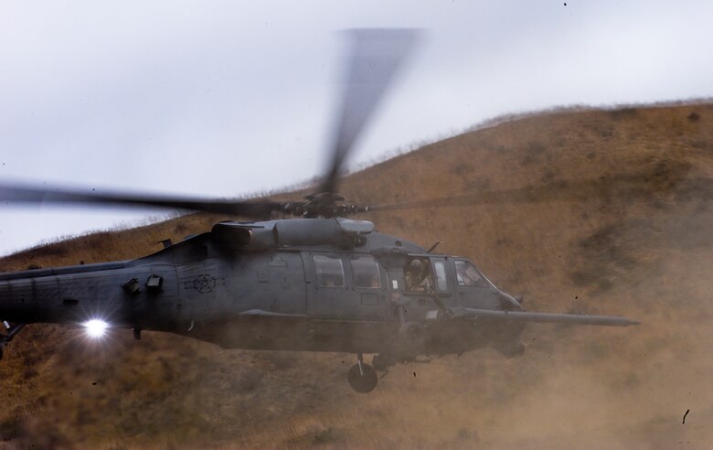 A U.S. Air Force HH-60G Pave Hawk takes off carrying simulated casualties during a mass casualty exercise apart of Angel Thunder 2015 at a training site outside of Marine Corps Base Camp Pendleton, Calif., June 11, 2015. The objective of the exercise was to clear the area of opposing forces and stablilze and safely extricate simulated casualties. (U.S. Air Force photo by Airman 1st Class Chris Drzazgowski/Released)