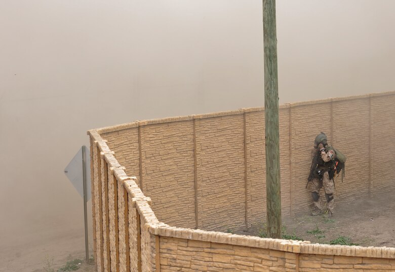 A German service member protects his face from dust as a German Army CH-53GS helicopter carrying U.S. and German service members, prepares to land during a mass casualty exercise apart of Angel Thunder 2015 at a training site outside of Marine Corps Base Camp Pendleton, Calif., June 11, 2015. The objective of the exercise was to clear the area of opposing forces and stablilze and safely extricate simulated casualties. (U.S. Air Force photo by Airman 1st Class Chris Drzazgowski/Released)