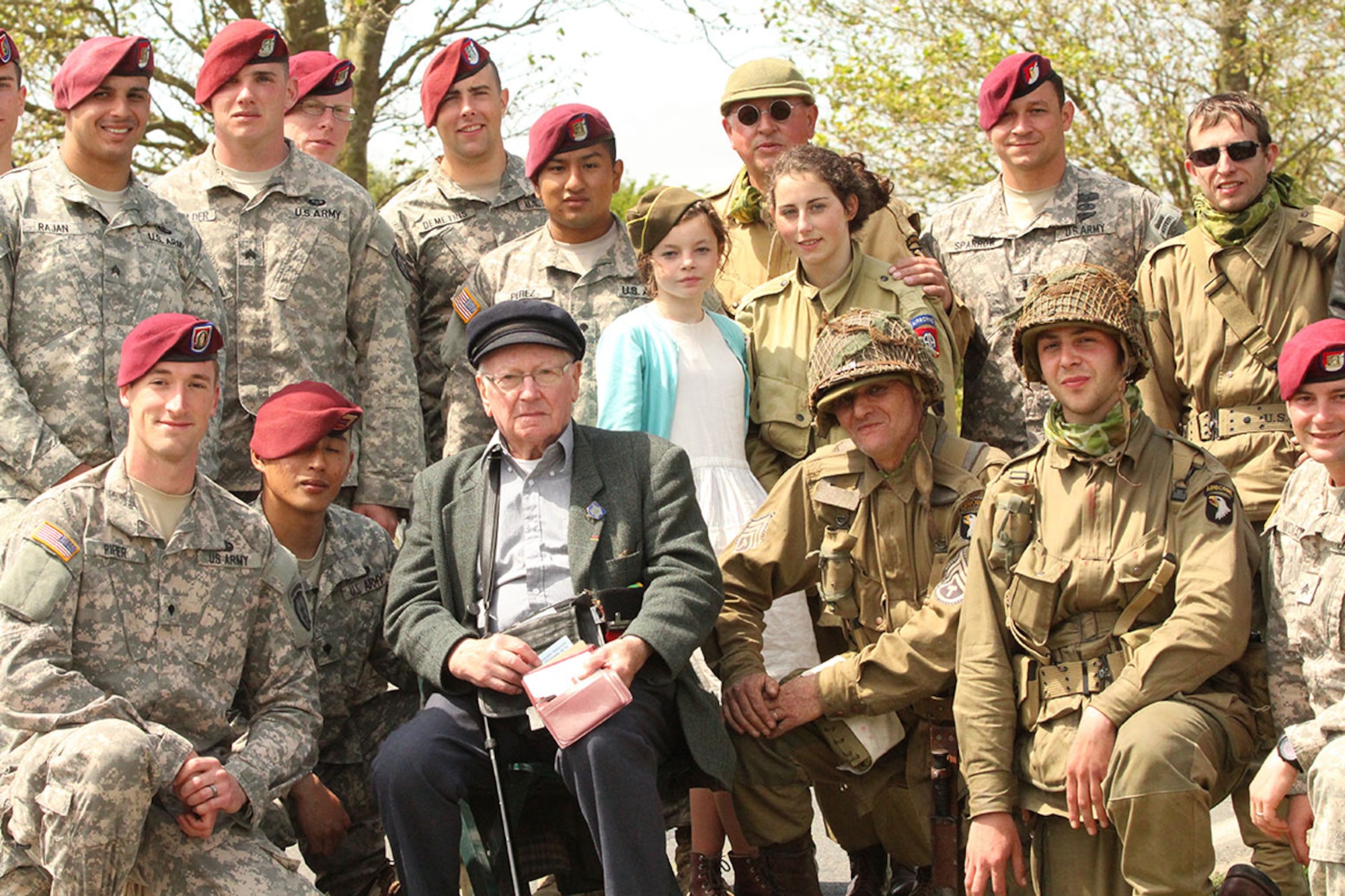 Paratroopers with the 4th Infantry Brigade Combat Team (Airborne), 25th Infantry Division from Joint Base Elmendorf-Richardson, pose with a WWII veteran. They received the opportunity of a lifetime to attend festivities marking the 71st anniversary of Operation Overlord June 2 through 8. (U.S. Army photo/Staff Sgt. Melissa Parrish)

