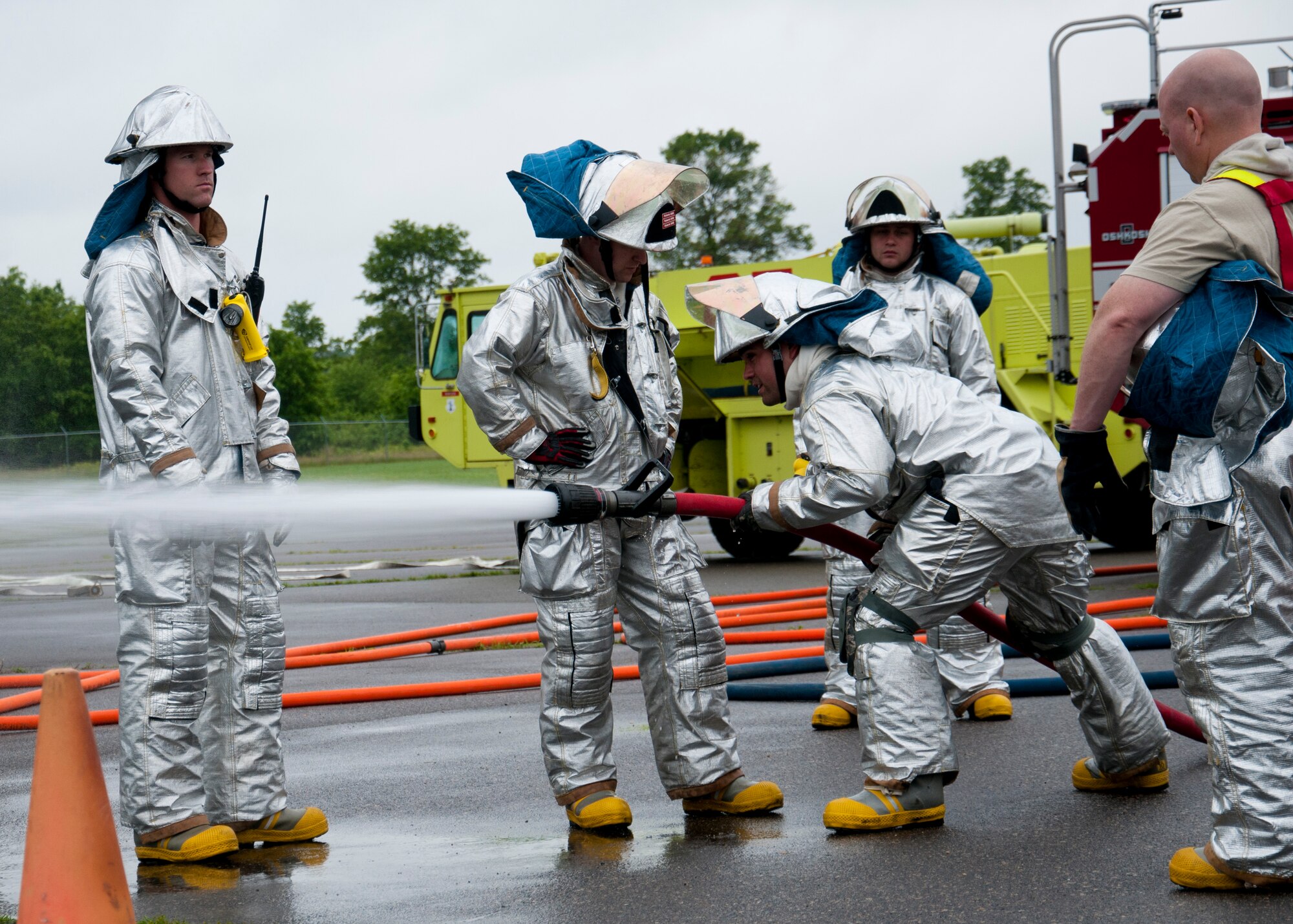 Members of the 446th Civil Engineer Squadron Fire Protection Flight train on proper hose technique at Fort McCoy WI. during Patriot Warrior, June 11th, 2015. Patriot Warrior is an Air Force Reserve Command exercise performed in a joint environment with U.S. Army and Navy Reserves, active duty and Air National Guard partners designed to evaluate the capability to deploy, establish and operate in support of joint operations. Nearly 6,000 U.S. Army Reserve, Navy Reserve and AFRC personnel took part in the exercise. The 446th Fire Protection Flight trained daily to keep their skills sharp in case of real world incidents during the exercise. (U.S. Air Force photo by Senior Airman Daniel Liddicoet/Released)
