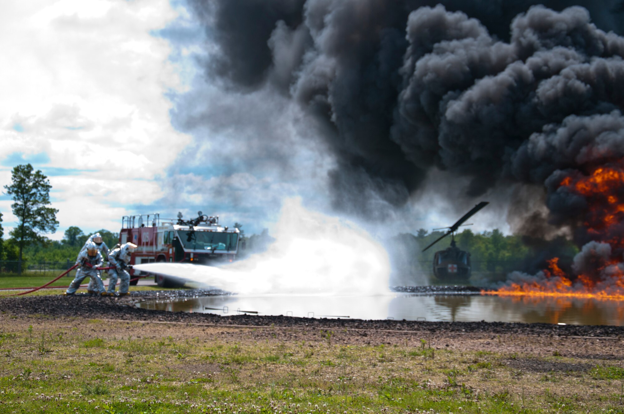 Members of the 446th Civil Engineer Squadron Fire Protection Flight train on putting out a JP8 jet fuel fire at Fort McCoy WI. during Patriot Warrior, June 10th, 2015. Patriot Warrior is an Air Force Reserve Command exercise performed in a joint environment with U.S. Army and Navy Reserves, active duty and Air National Guard partners designed to evaluate the capability to deploy, establish and operate in support of joint operations. Nearly 6,000 U.S. Army Reserve, Navy Reserve and AFRC personnel took part in the exercise. The 446th Fire Protection Flight team had a unique opportunity to train with JP8 jet fuel during the exercise, which simulates the conditions of real fires they might encounter much more closely than propane. (U.S. Air Force photo by Senior Airman Daniel Liddicoet/Released)