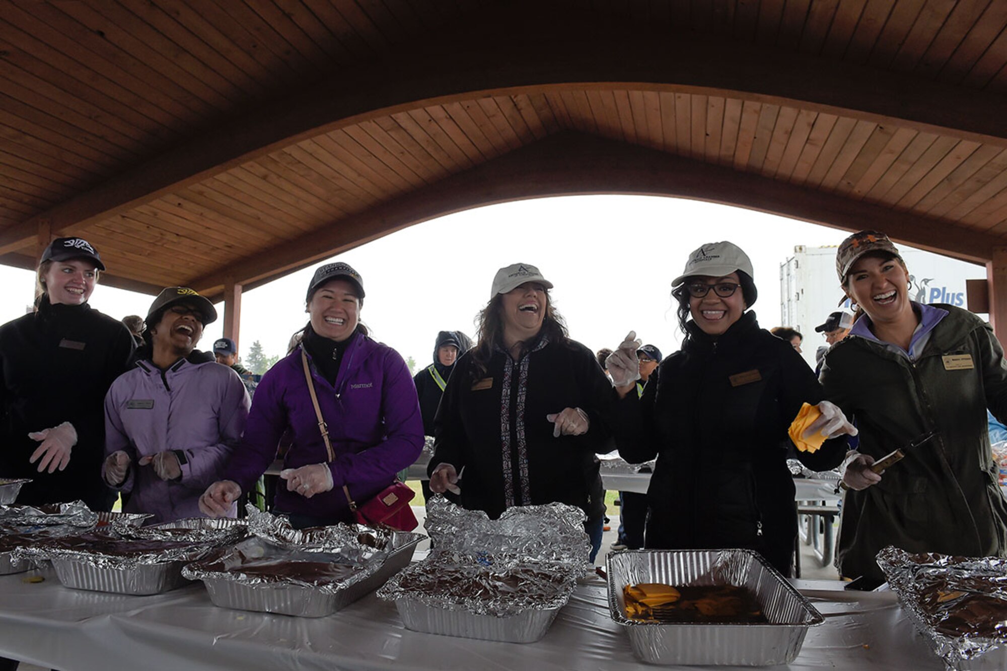 Volunteers stand ready serve lunch to Airmen, Soldiers and civilian guests during the Military Appreciation Picnic. The picnic is hhosted every year in conjunction with the Arctic Warrior Olympics. (U.S. Air Force photo/Alejandro Pena) 