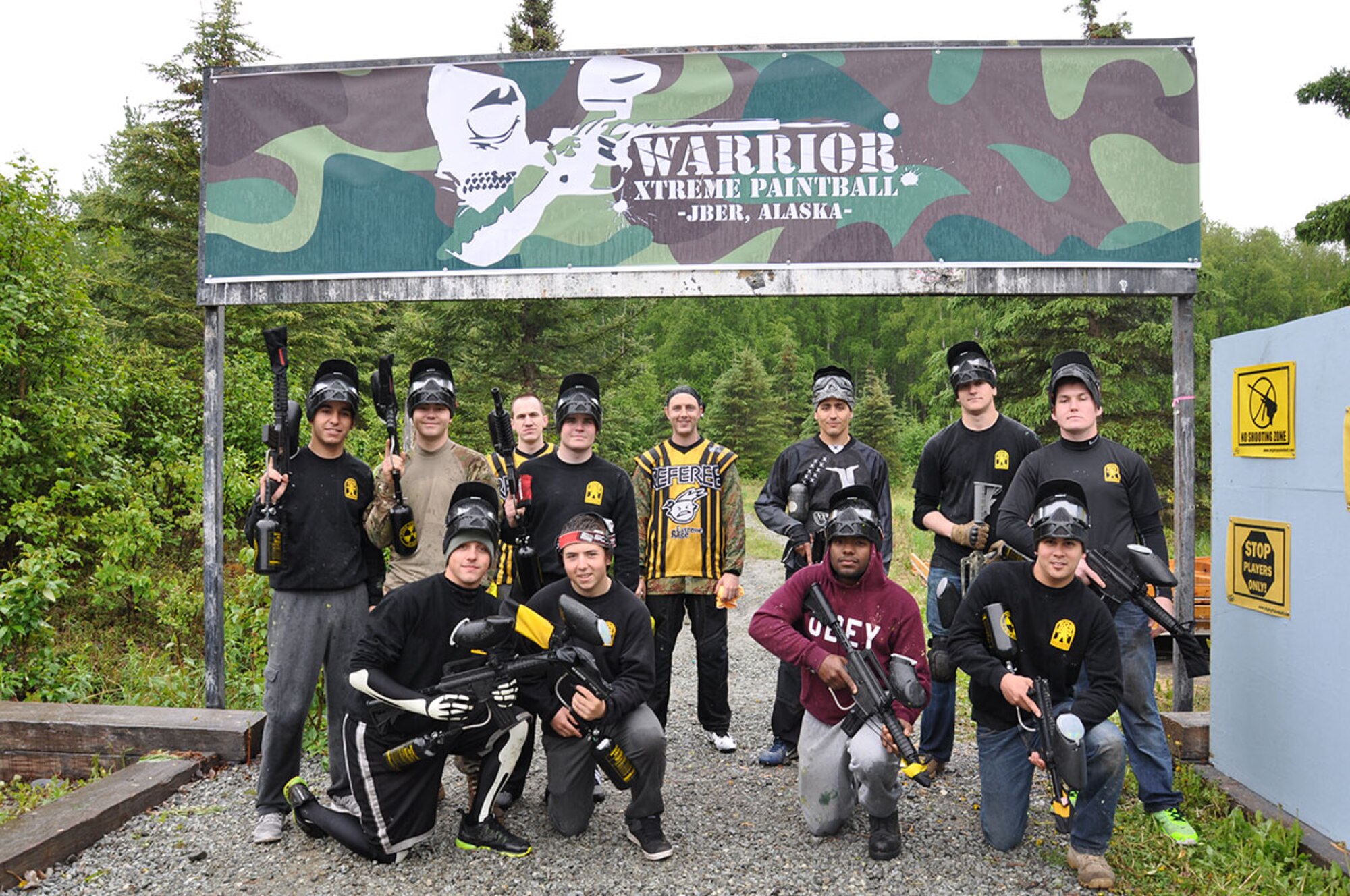 The 3-509 team 2 and 3-509 team 5 and two referees take time for a photo before going into battle for a capture-the-flag finale. A team from the 3rd Battalion, 509th Infantry Regiment (Airborne) dominated the paintball shootout during the Arctic Warrior Olympics June 5.  (U.S. Air Force photo/Erin Eaton)