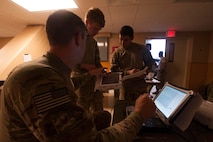 U.S. Air Force Master Sgt. Cory Hebb, left, 820th Combat Operations Squadron superintendent, prepares the white cell exercise headquarters for a RQ-11B Raven video stream during Exercise DRAGON STRIKE June 10, 2015, at Avon Park Air Force Range, Fla. Hebb live-streamed the M142 High Mobility Artillery Rocket System launches for the white cell to view. (U.S. Air Force photo by Airman 1st Class Dillian Bamman/Released)