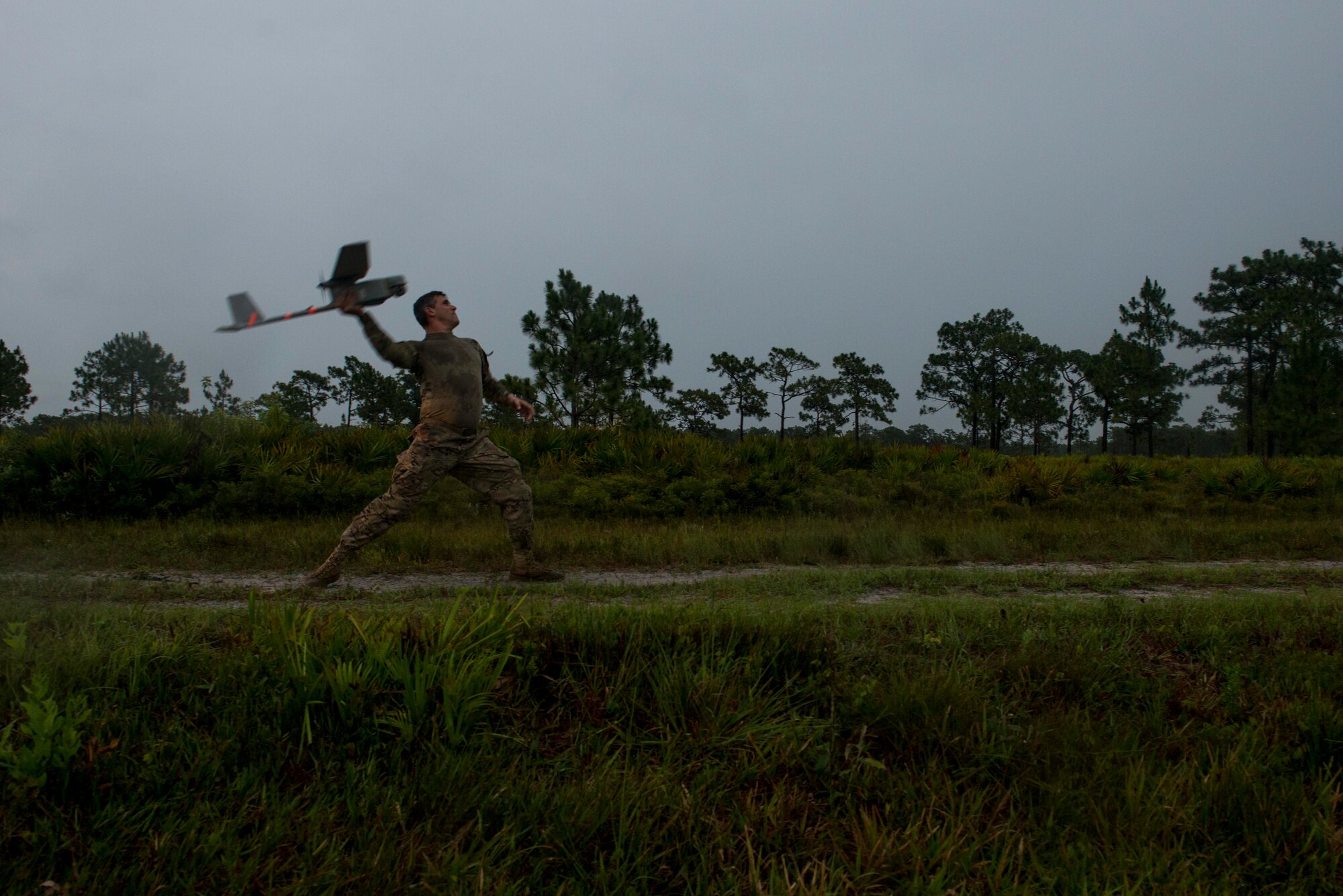 U.S. Air Force Master Sgt. Cory Hebb, 820th Combat Operations Squadron superintendent, throws an RQ-11B Raven for flight during Exercise DRAGON STRIKE June 10, 2015, at Avon Park Air Force Range, Fla. Hebb utilized the Raven to survey the area before an M142 High Mobility Artillery Rocket System launch. (U.S. Air Force photo by Airman 1st Class Dillian Bamman/Released)