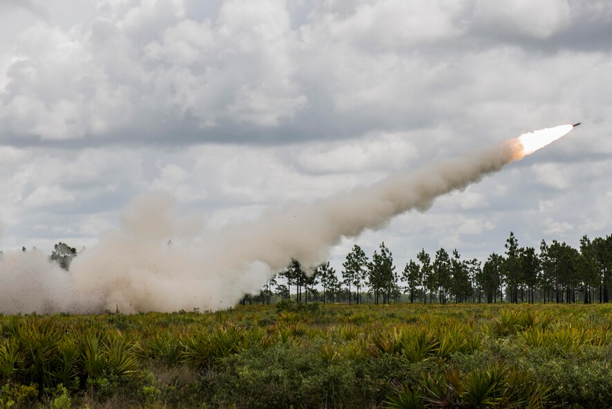 The 3-27th Field Artillery Regiment launches an M142 High Mobility Artillery Rocket System (HIMARS) rocket during Exercise DRAGON STRIKE June 10, 2015, at Avon Park Air Force Range, Fla. The 3-27th FAR worked alongside the 18th Air Support Operations Group, 820th Base Defense Group, 23d Maintenance Group and 23d Fighter Group. (U.S. Air Force photo by Airman 1st Class Dillian Bamman/Released)