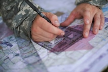 U.S. Army Sgt. Christopher Nance, 3-27th Field Artillery Regiment 2nd Fires Platoon operations chief, maps target areas during Exercise DRAGON STRIKE June 10, 2015, at Avon Park Air Force Range, Fla. Nance and his platoon coordinated with 93d Air Ground Operations Wing joint terminal attack controllers on where to launch their M142 High Mobility Artillery Rocket System rockets for accurate threat elimination. (U.S. Air Force photo by Airman 1st Class Dillian Bamman/Released)