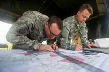 U.S. Army 2nd Lt. Blaine Bradburn, right, 3-27th Field Artillery Regiment 2nd Fires Platoon leader, and Sgt. Christopher Nance, 3-27th FAR 2nd Fires Platoon operations chief, map target areas during Exercise DRAGON STRIKE June 10, 2015, at Avon Park Air Force Range, Fla. DRAGON STRIKE was a joint exercise focusing on joint terminal attack controller communications. (U.S. Air Force photo by Airman 1st Class Dillian Bamman/Released)