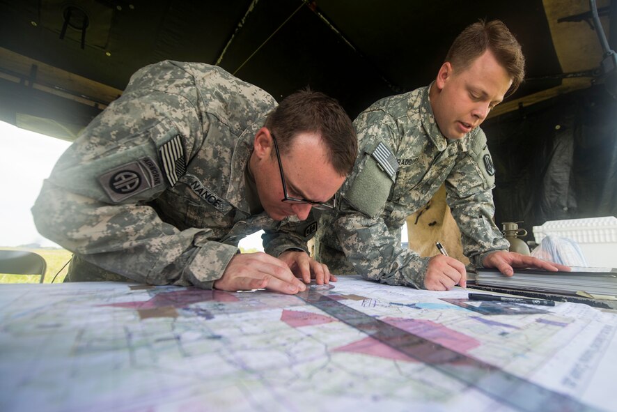 U.S. Army 2nd Lt. Blaine Bradburn, right, 3-27th Field Artillery Regiment 2nd Fires Platoon leader, and Sgt. Christopher Nance, 3-27th FAR 2nd Fires Platoon operations chief, map target areas during Exercise DRAGON STRIKE June 10, 2015, at Avon Park Air Force Range, Fla. DRAGON STRIKE was a joint exercise focusing on joint terminal attack controller communications. (U.S. Air Force photo by Airman 1st Class Dillian Bamman/Released)