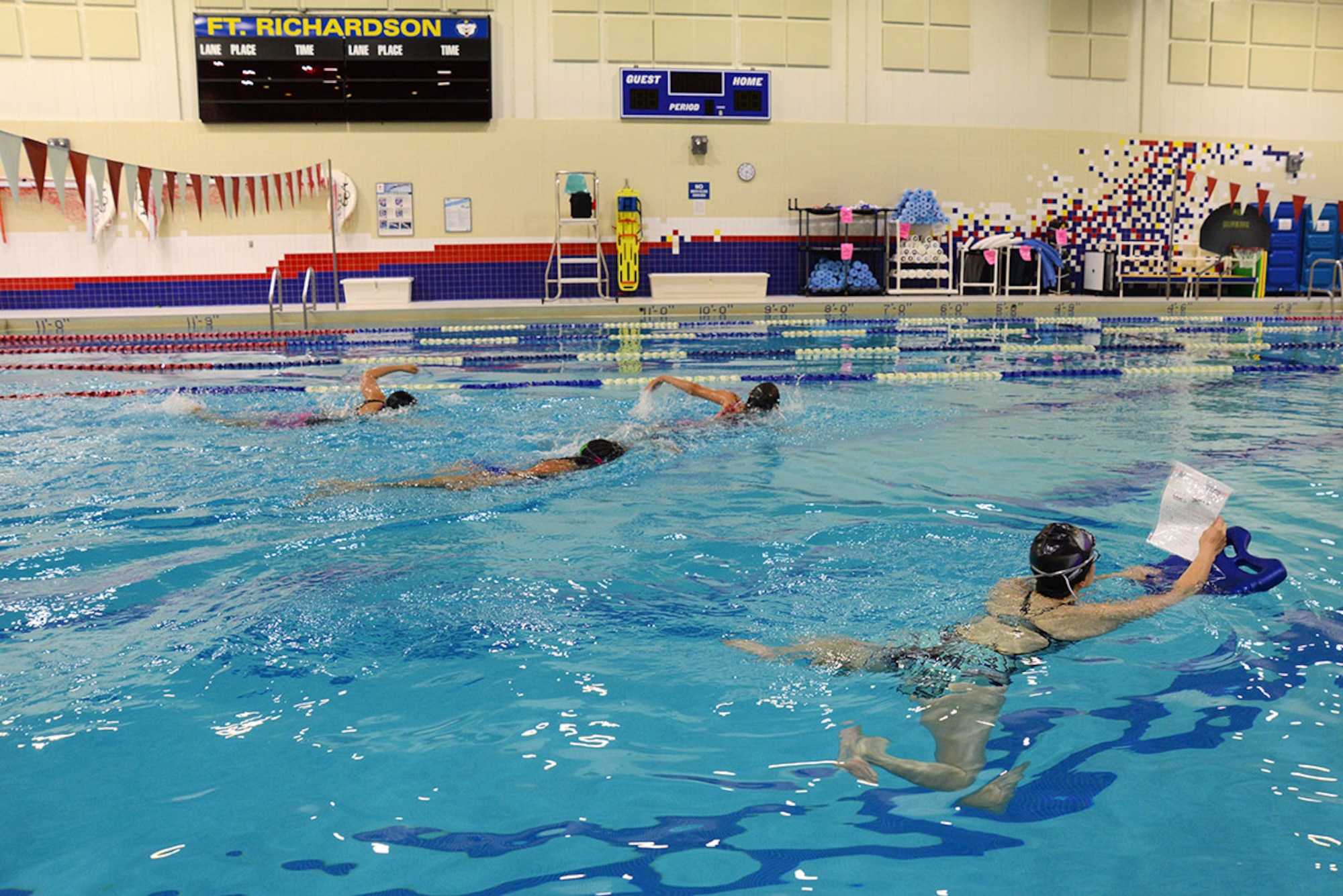 Mae-Lin Ynacay (right), lifeguard and water safety instructor with the Joint Base Elmendorf-Richardson’s Buckner Physical Fitness Center, leads a swimming lesson for four patrons on June 2. The center’s advanced ‘Learn to Swim’ lessons solidify new techniques of swimming and underwater control. (U.S. Air Force photo/Airman Christopher R. Morales)