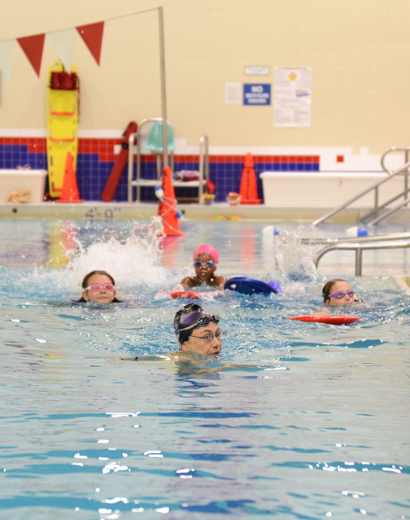 Mae-Lin Ynacay (front), lifeguard and water safety instructor with the Buckner Physical Fitness Center, leads four pool patrons in a swimming lesson on Joint Base Elmendorf-Richardson, Alaska, June 2. The center’s ‘Learn to Swim’ lessons teach new swimming techniques, quirks and tips for perfecting the basics of swimming. (U.S. Air Force photo/Airman Christopher R. Morales)