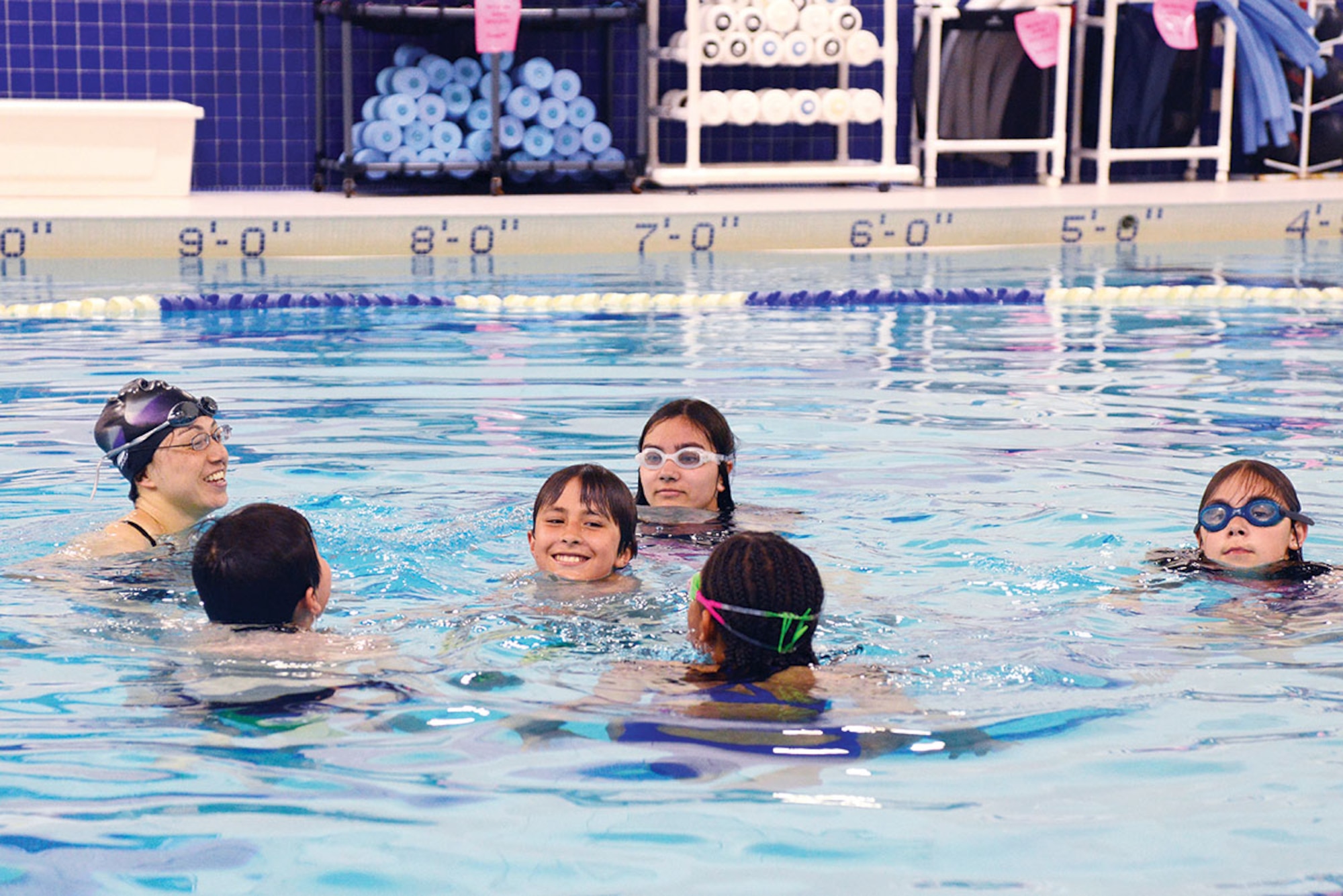 Mae-Lin Ynacay (far left), lifeguard and water safety instructor, leads her students in treading practice at Buckner Physical Fitness Center June 2. The center’s ‘Learn to Swim’ lessons solidify new techniques of swimming and underwater control. (U.S. Air Force photo/Airman Christopher R. Morales)