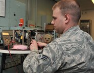 Senior Airman Travis Grimit, 341st Missile Maintenance Squadron missile communications instructor, verifies the operation of mass storage unit June 10 at Malmstrom Air Force Base, Mont., before the device is installed at one of Malmstrom’s 15 launch control centers. The missile communications section has its own electronics laboratory, and maintains and repairs communications systems used in LCCs and the Support Information Network to Malmstrom’s 150 launch facilities. (U.S. Air Force photo/John Turner)
