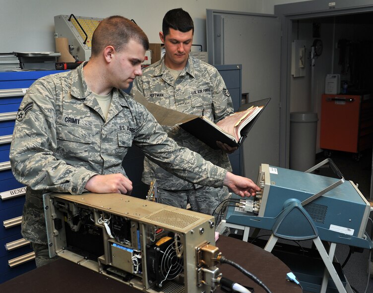 Senior Airman Travis Grimit (left) and Staff Sgt. Donald Hoffman, both from the 341st Missile Maintenance Squadron missile communications section, verify a mass storage unit is operating properly June 10 at Malmstrom Air Force Base, Mont. Missile communications technicians maintain the nuclear command and control communications systems at each of Malmstrom’s 15 launch control centers and the Support Information Network between LCCs and Malmstrom’s 150 Minuteman launch facilities. (U.S. Air Force photo/John Turner)