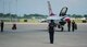 A member of the U.S. Air Force Thunderbirds stands at attention following an aerial performance June 14, 2015, during the Wings Over Whiteman Air Force Base, Mo. The U.S. Air Force Air Demonstration Squadron performs precision aerial maneuvers demonstrating the capabilities of Air Force high performance aircraft to people throughout the world. (U.S. Air Force photo by Senior Airman Joel Pfiester/Released)
