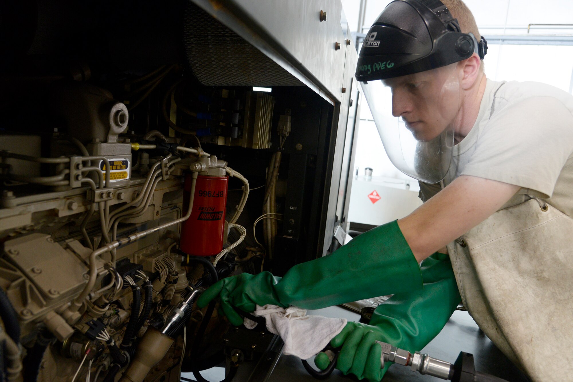 Senior Airman Joseph DeArment, 2nd Maintenance Squadron aerospace ground equipment journeyman, uses the new oil safe lubrication work center system to service a generator at Barksdale Air Force Base, La., June 12, 2015. The new system enables flightline drivers and maintainers a quick and efficient way to service equipment. (U.S. Air Force photo/Tech. Sgt. Marie Brown) 