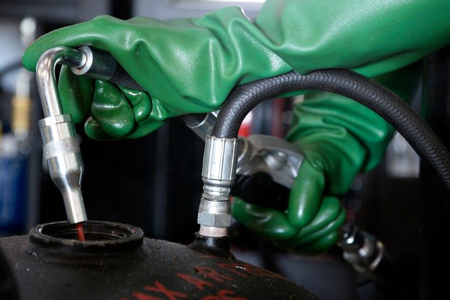 Airman 1st Class Ryan Thomas, 2nd Maintenance Squadron aerospace ground equipment journeyman, fills an oil servicing cart using the new oil safe lubrication work center system at Barksdale Air Force Base, La., June 12, 2015. The new system houses eight 65-gallon tanks, which are self-contained and easily accessed using pressurized dispensing taps or a 25-foot hose reel. (U.S. Air Force photo/Tech. Sgt. Marie Brown)