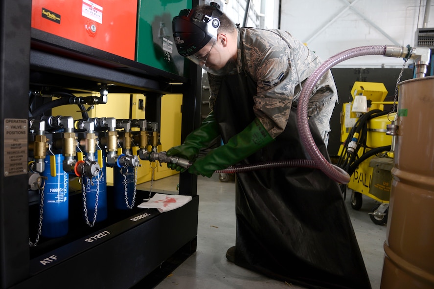 Airman 1st Class Ryan Thomas, 2nd Maintenance Squadron aerospace ground equipment journeyman, connects a hose to the new oil safe lubrication work center system at Barksdale Air Force Base, La., June 12, 2015. The new system houses eight 65-gallon tanks filled with four different types of engine oils and four different types of hydraulic fluid. (U.S. Air Force photo/Tech. Sgt. Marie Brown)