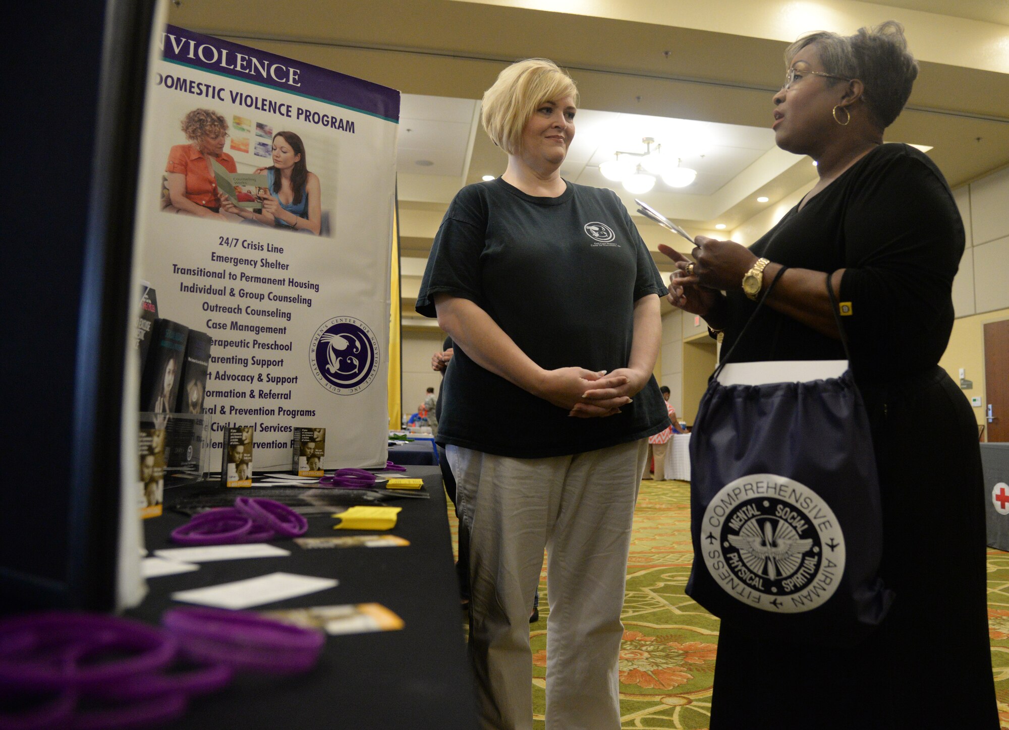 Rene Davis, Gulf Coast Women’s Center for Nonviolence outreach prevention educator, gives information about services the program provides to Sonia Murrah, Base Exchange vender, at the Wingman Week Resilience Fair, June 12, 2015, Keesler Air Force Base, Miss. The fair gave Airmen, dependents and base personnel information about different programs provided through on and off base agencies. (U.S. Air Force photo by Senior Airman Holly Mansfield)